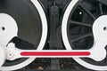 Black wheel of train with white and red mechanism Royalty Free Stock Photo