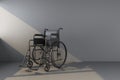 Black wheelchair in beam of light