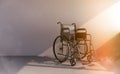 Black wheelchair in beam of light