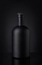 Black whiskey bottle on dark background