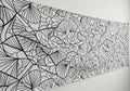 Black and white abstract line art on a rectangular sheet mounted on a white wall. The design Royalty Free Stock Photo
