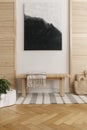 Black and white abstract painting above wooden table in natural designed interior