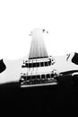 Black and white abstract silhouette of a guitar on a white background. Royalty Free Stock Photo