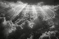 A black and white aerial photograph of the sun shining through a dense layer of clouds, Subtle rays of light peeking through the Royalty Free Stock Photo