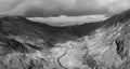 Black and white Aerial view of flying drone Epic landscape image in Autumn looking down Nant Fracon valley from Llyn Idwal with
