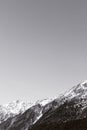 Black-and-white Alpine background. High mountains with snow Royalty Free Stock Photo