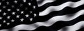 A black and white American flag waving on a black background. Flag of USA. Royalty Free Stock Photo