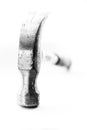 A black and white art studio isolated portrait of a metal hammer lying on the face with the claw facing up. The handle of the tool Royalty Free Stock Photo