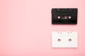 Black and white audio cassettes on pink background