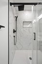 Black and white bathroom with a shower and a glass door Royalty Free Stock Photo