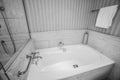 Black and white bathtub with luxury faucet and towel for bathing in hotel Royalty Free Stock Photo