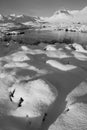 Black and white Beautiful Winter landscape image looking towards Scottish Highlands mountain range across Loch Ba on Rannoch Moor Royalty Free Stock Photo