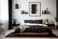 a black and white bedroom featuring a basic bed frame and nightstand