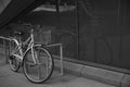 Black and White Bicycle Leaning Against a Railing