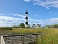 Black and white Bodie Lighthouse with a wooden boardwalk