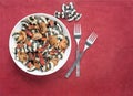 Black and White Bow Tie Pasta Dish with Forks on Rust Background