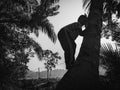 Black and white a boy is climbing a coconut tree