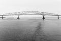 Black & white bridge, barge over New Jersey Harbor Royalty Free Stock Photo