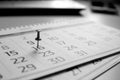 Black and white calendar grid is on the table