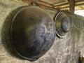 Black and white cauldron hanging on the wall of the house