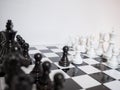 Black and white chess-Army are standing on a board with white background, challenges planning business strategy to success concept