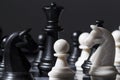 Black and white chess figures on chessboard. Checkmate game process Royalty Free Stock Photo