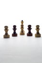 Black and white chess pawns and queen on a white background Royalty Free Stock Photo