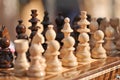 Black and white chess pieces on a chessboard, closeup. Set of chess figures on the playing board Royalty Free Stock Photo