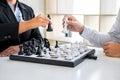 Black and White chess with player, Businessman and Businesswoman thinking strategy to moving chess figure in competition with