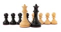 Black and white chess queens in front of pawns on white background. Competition concept Royalty Free Stock Photo