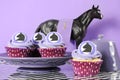 Black and white chevron with purple theme racing party cupcakes.