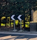 Black and white chevron sign pointing left