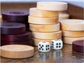 Backgammon. Board game. White cubes and chips on a blackboard. Royalty Free Stock Photo