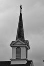 Black and white of a Christian Church steeple with a cross at the top Royalty Free Stock Photo
