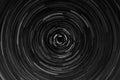 Black and white circular blur in the form of a whirl background texture, radial blur, abstract twist, funnel