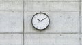 A black and white clock on a concrete wall. Royalty Free Stock Photo