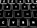 Black and white close-up on illuminated keys of computer keyboard