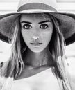 Black and white close-up portrait of a young beautiful caucasian girl with a pretty face and big eyes wearing a hat on a warm summ Royalty Free Stock Photo