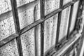 Aged and worn, antique english wooden door with iron bars on brick, black and white Royalty Free Stock Photo