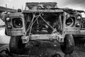 Black and white close up of a wrecked offroad truck