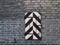 Black and white closed shutters in a red brick wall Royalty Free Stock Photo