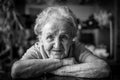 Black-and-white closeup portrait of an elderly positiv woman.