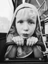 Black and white closeup portrait of funny little girl in bus and making funny silly faces with duck face lips Royalty Free Stock Photo