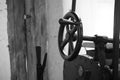 Black and white closeup of the steering wheel of a road roller Royalty Free Stock Photo