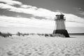 a black and white coastal lighthouse standing tall by a sandy beach