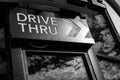 Black and white of Coffee drive thru sign with reflect from glass window