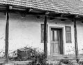 Black and white composition with the front entrance of an old house with small windows and wooden beams Royalty Free Stock Photo