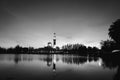 Black and white concept of beautiful floating mosque on the lake surrounded by tree and coconut tree during sunset. Royalty Free Stock Photo