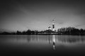 Black and white concept of beautiful mosque surrounded lake and coconut tree during sunset. Royalty Free Stock Photo