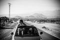 Black and white conceptual travel and adventure with friends concept with couple of young middle age women traveling on a